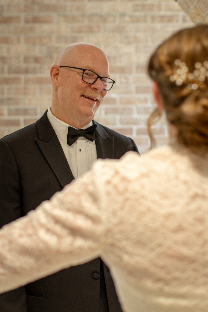 A father hugs his daughter in an emotional moment before the wedding ceremony.