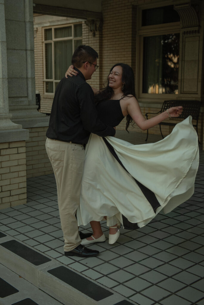 A joyful moment of a couple laughing and holding each other closely.