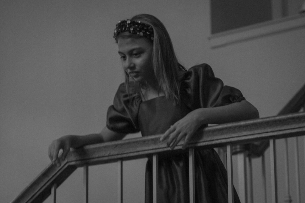 Black and white bridal portrait captured indoors during an intimate wedding day, emphasizing emotion and storytelling.