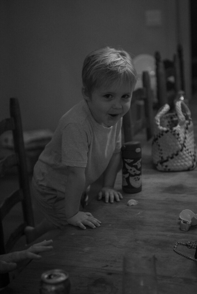 Black and white candid photo of a child during an intimate family elopement celebration