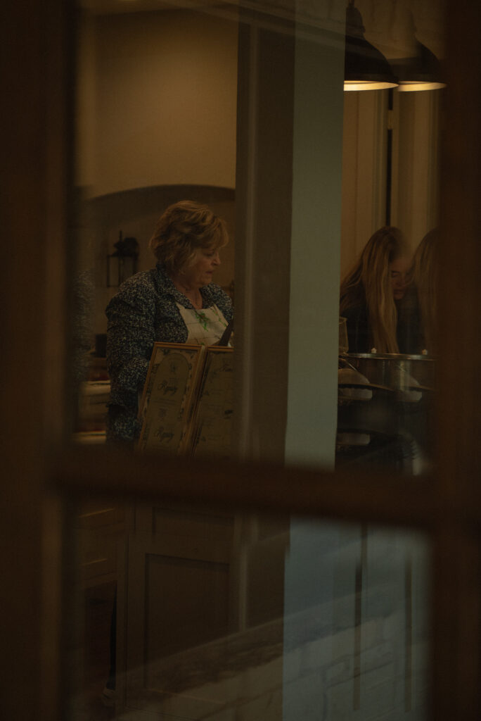 Candid documentary wedding moment of family preparing food inside a Texas Hill Country elopement home.