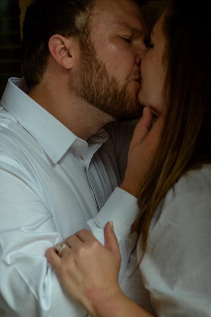 A close-up of a couple kissing during their courthouse elopement photography session.