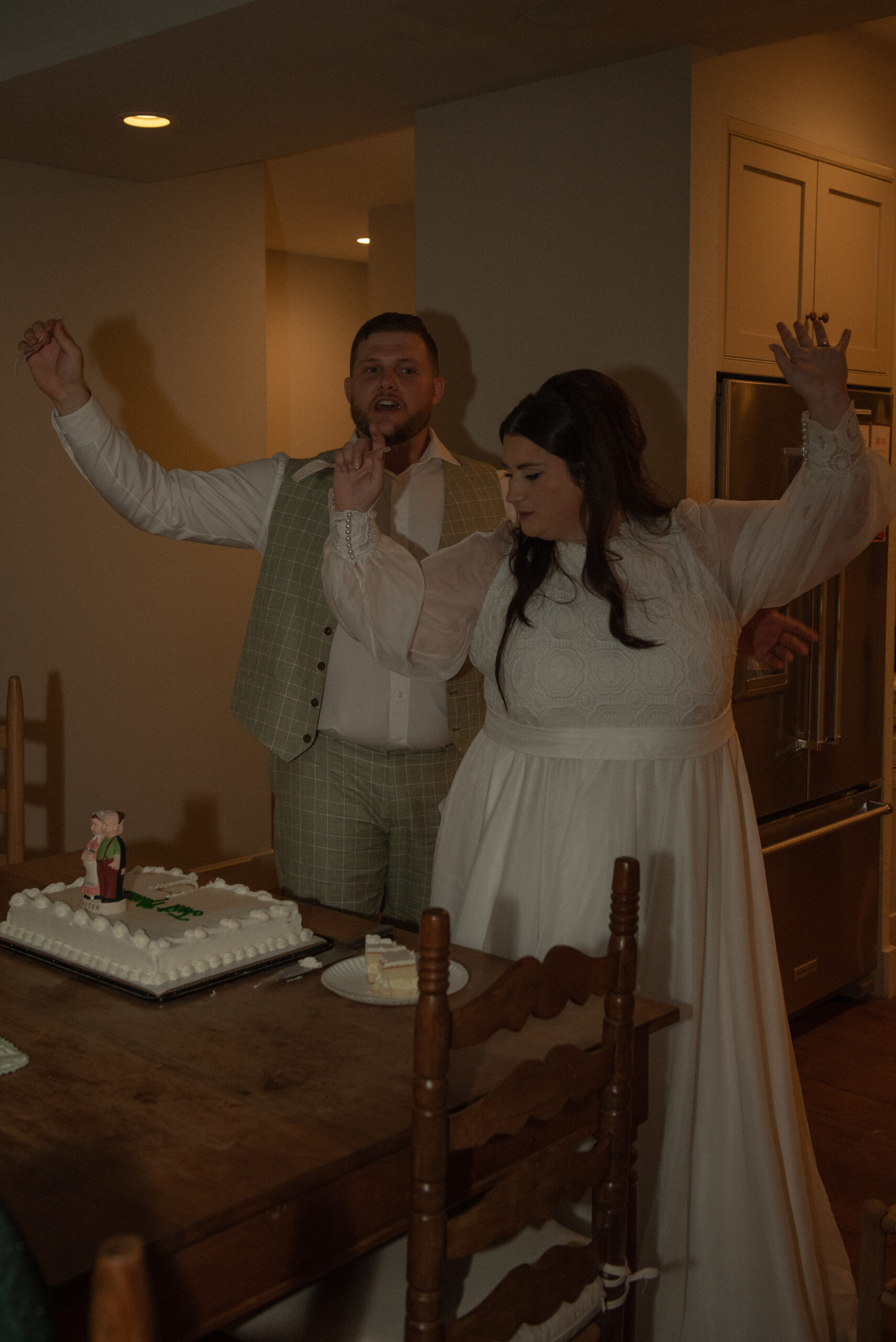 Newly married couple dancing together indoors during a relaxed elopement celebration