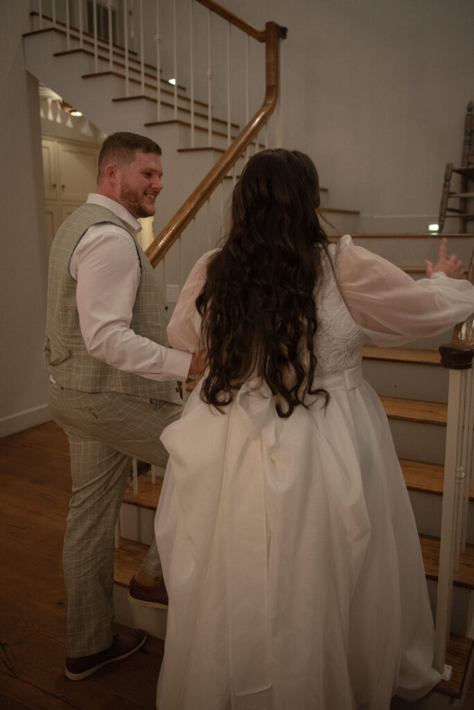 Bride and groom walking upstairs together during an intimate Texas elopement day