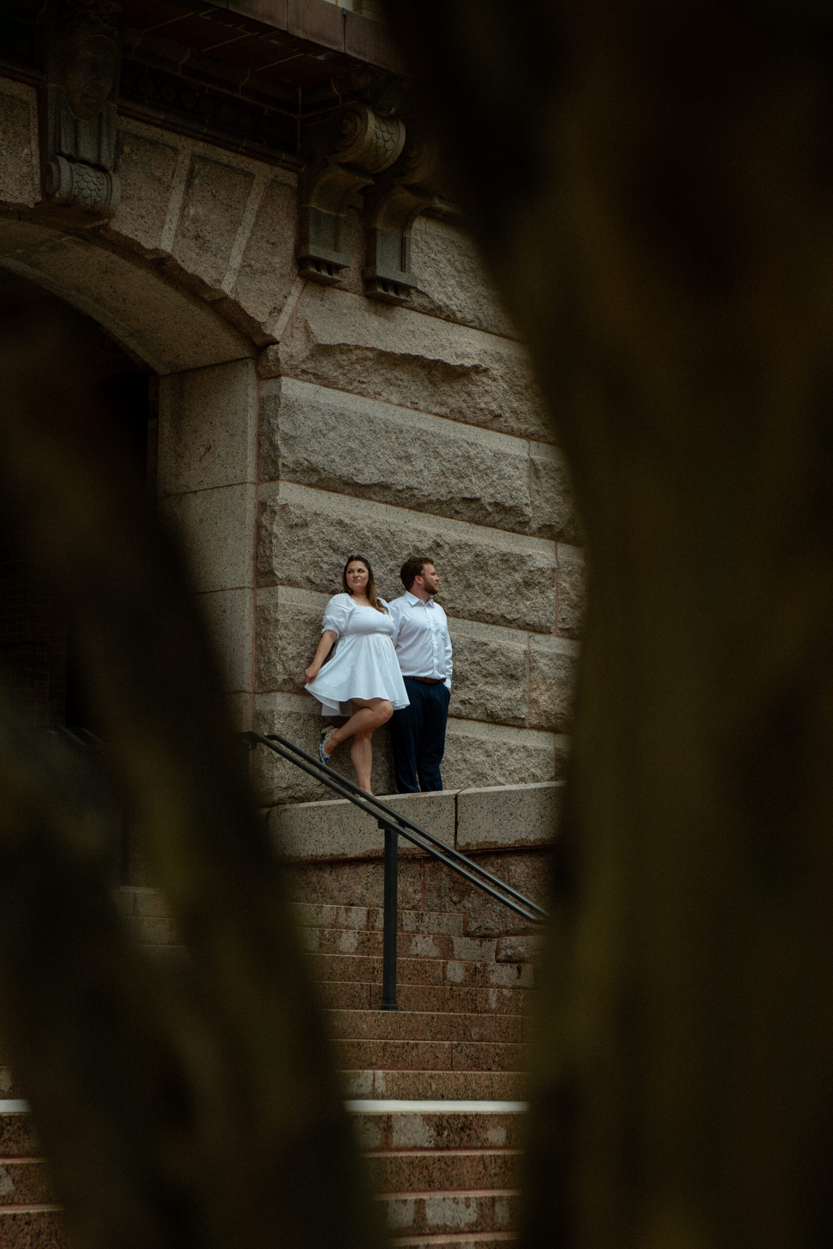 A couple standing on the steps of the historic 1910 Houston Courthouse during their elopement session.