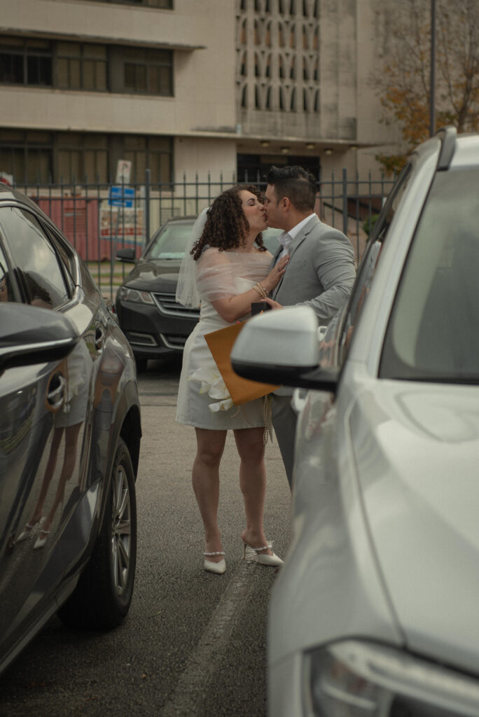 Just married couple kissing outside a Houston courthouse in downtown Houston.