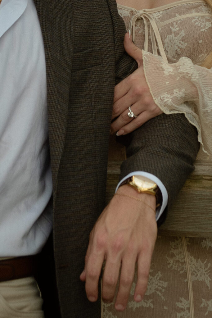 Close up of an engagement ring on a woman's hand during a romantic outdoor engagement session with natural light