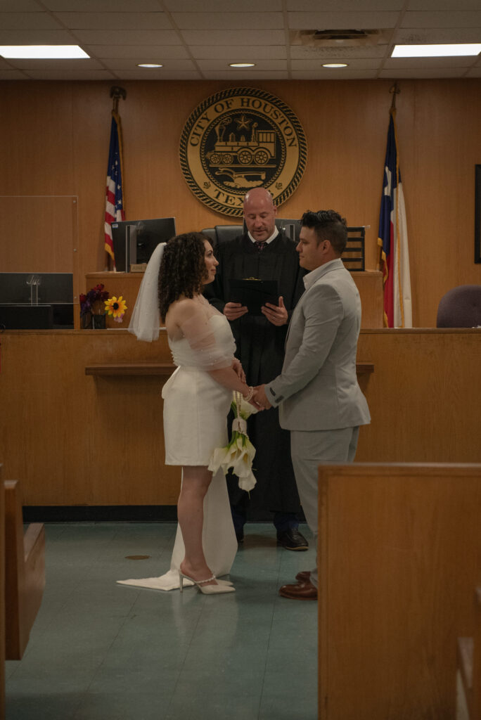 Courthouse wedding ceremony in a Houston courtroom with a judge officiating an intimate elopement.