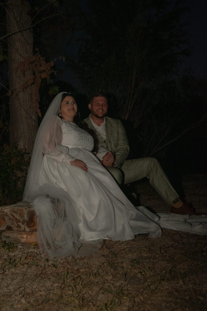 Newly married couple sitting together during evening elopement portraits in the Texas Hill Country