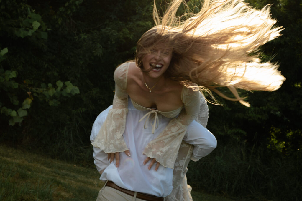 Joyful engagement photo of a couple laughing together outdoors during a relaxed Houston engagement session