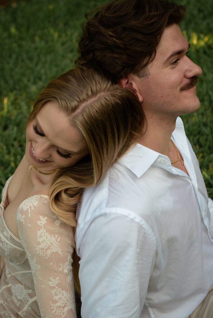 Romantic back to back engagement portrait of a couple at Mercer Botanic Gardens in Houston Texas