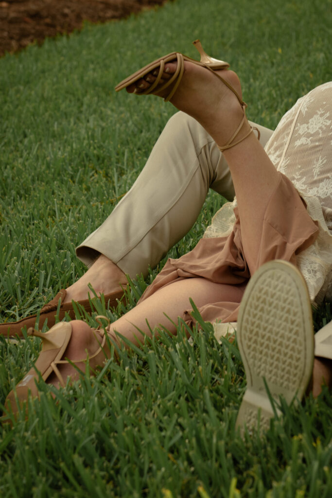 Candid engagement photo detail of a couple relaxing on the grass at Mercer Botanic Gardens in Houston Texas