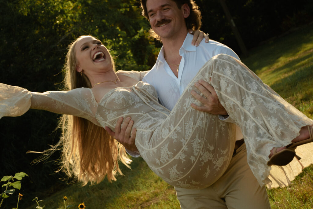 Playful engagement photo of a couple laughing together during a golden hour outdoor engagement session