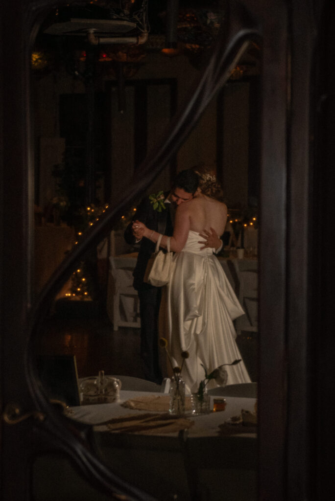 Bride and groom share a private last dance inside the reception venue.