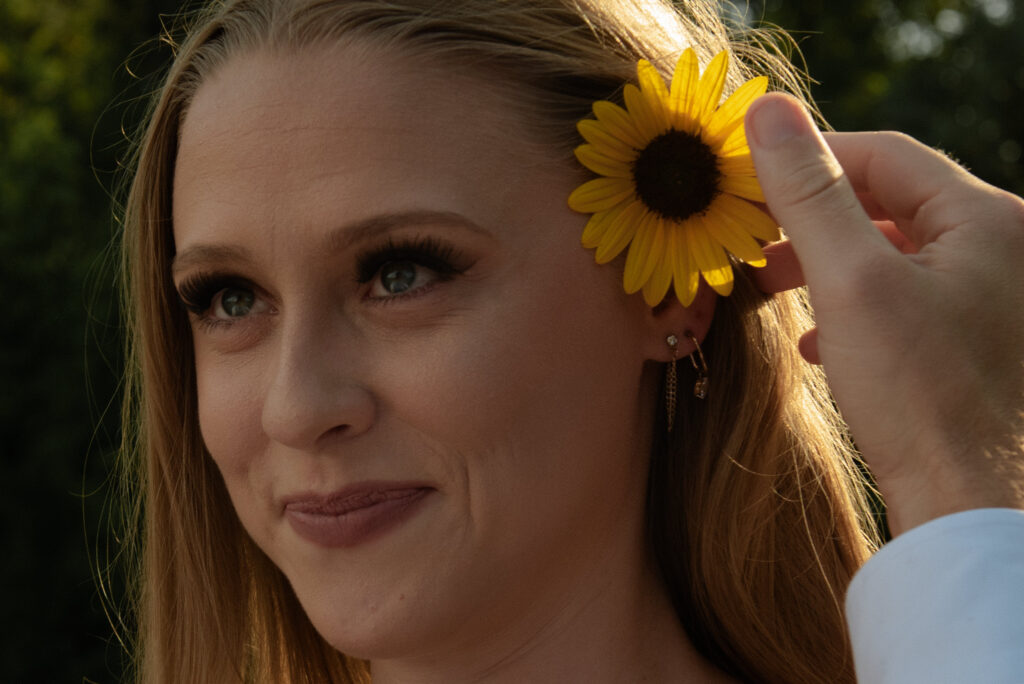 Close up engagement portrait of a woman smiling during a romantic summer engagement session with natural light