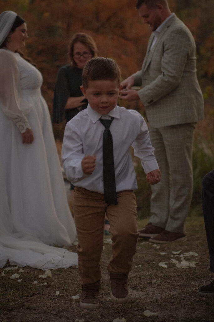 Child walking down the aisle during an intimate outdoor elopement ceremony in Texas