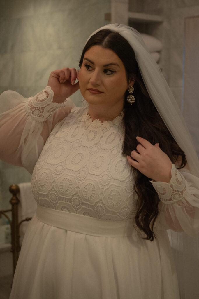 Bride getting ready in a lace wedding dress during a Texas Hill Country elopement, captured in a soft documentary style.