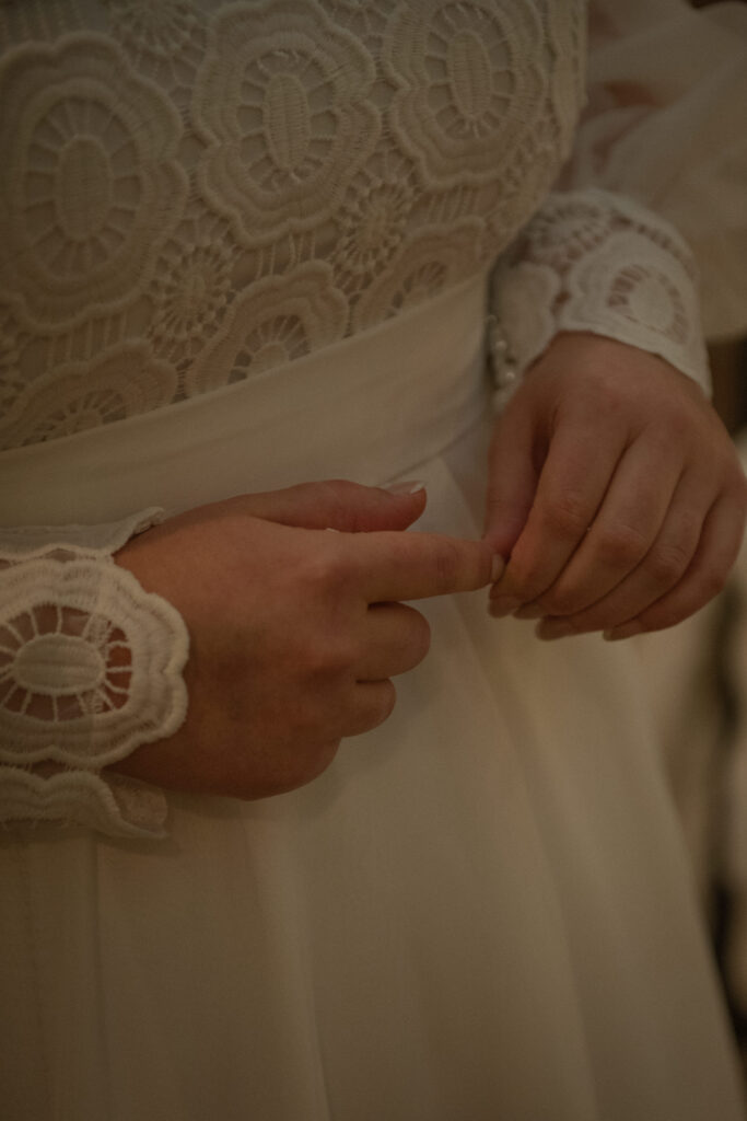 Close-up of lace wedding dress details during an intimate elopement in the Texas Hill Country.