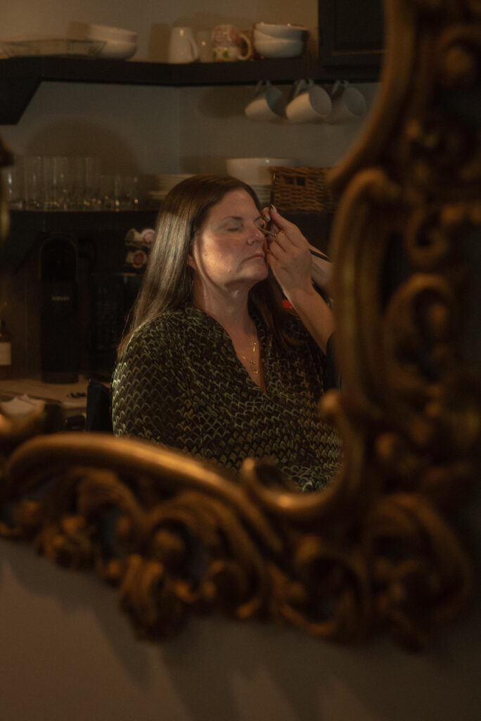 Wedding makeup being applied during elopement day preparations in the Texas Hill Country.