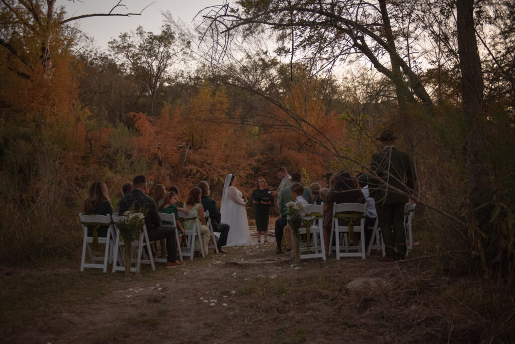Wide view of an outdoor elopement ceremony surrounded by nature in Wimberley Texas