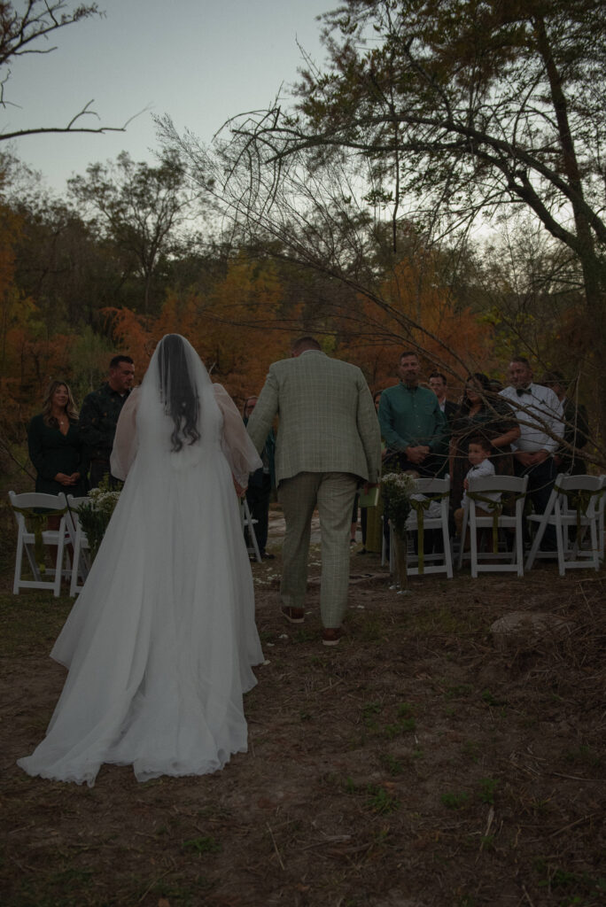 Couple walking down the aisle during an outdoor elopement ceremony in Wimberley Texas