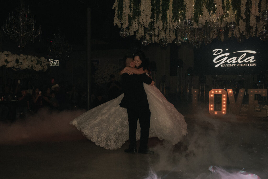 First dance with low fog and marquee LOVE letters at a wedding reception.