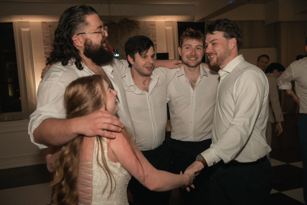 Bride dancing with friends on the dance floor during a wedding reception.